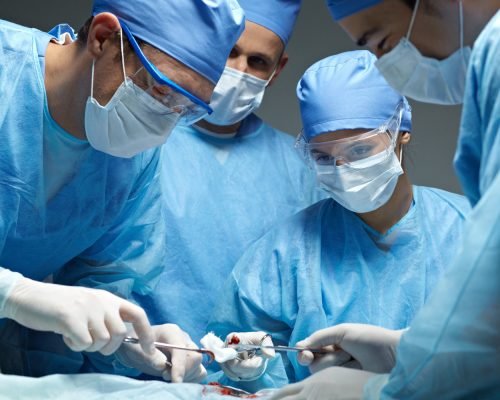 Medical team performing an operation in operating theater